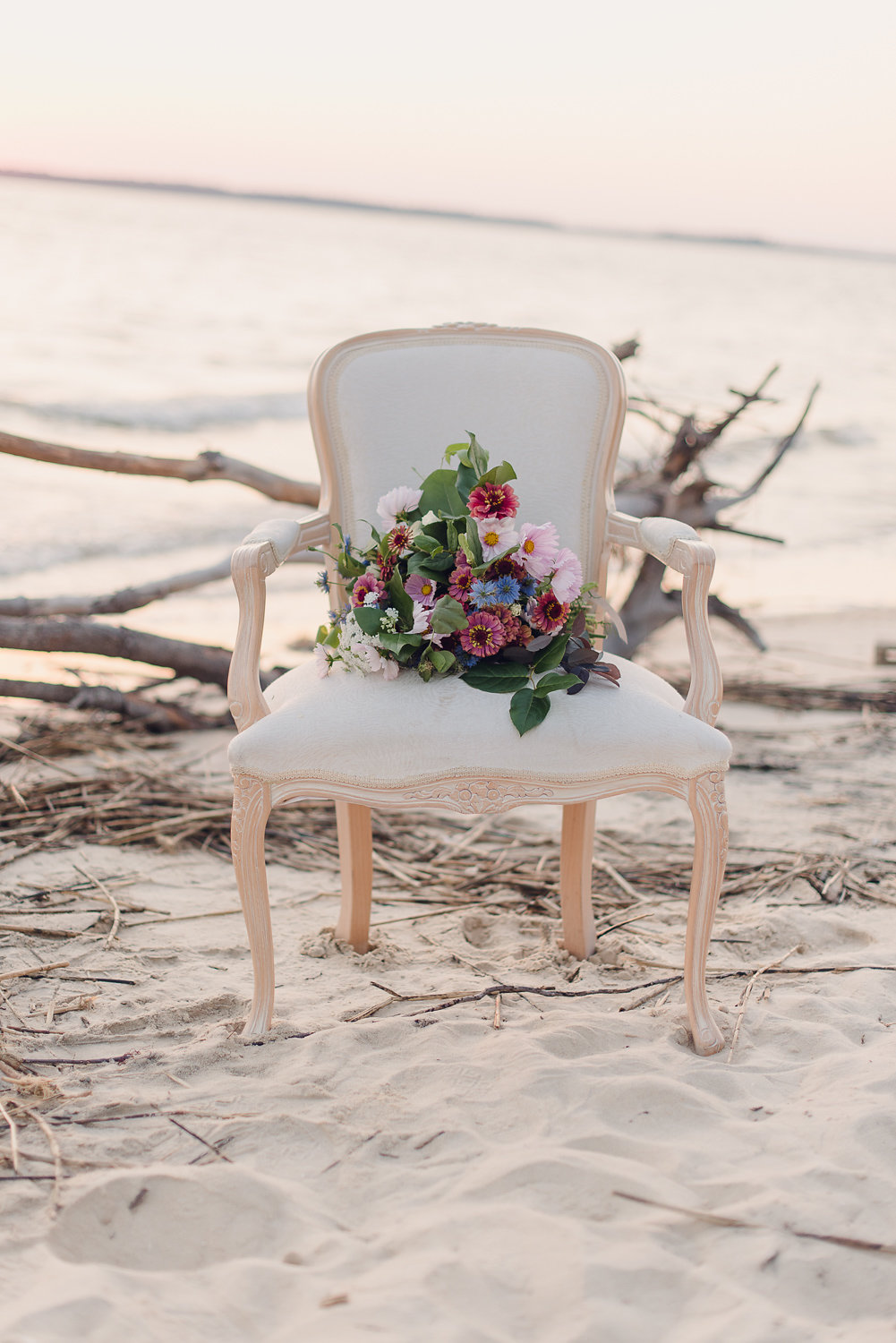 Fine art wedding details including custom place settings and lush floral arrangements